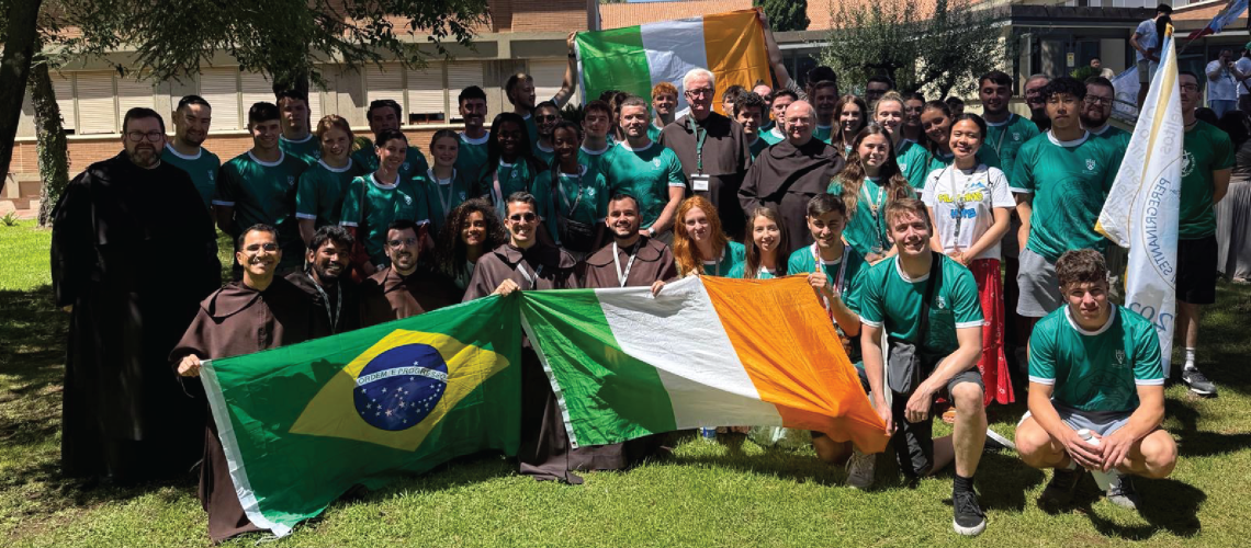 Group of 50 Irish pilgrims pose for a photo in Rome with Ireland flags.