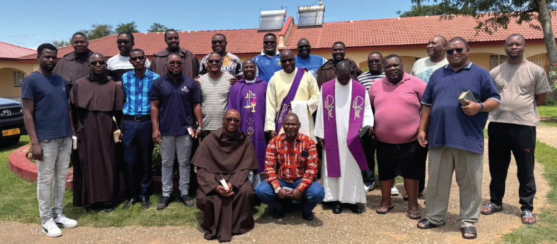Members of the Carmelite retreat pose for a photo outside of Prophet Elijah Priory, in Zimbabwe.